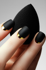  Black matte nail polish. Manicured nail with black matte nail polish