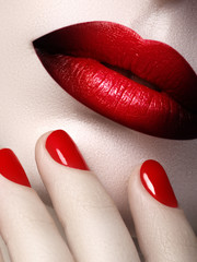 Red Sexy Lips and Nails closeup. Open Mouth. Manicure and Makeup