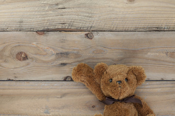 Teddy bear on old wood background.