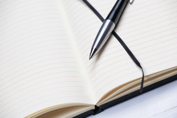 White notepad notebook lines elegant pen wooden background