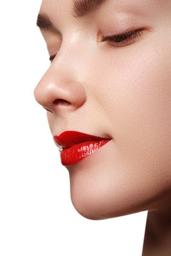 Close-up shot of woman lips with red lipstick