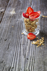 Healthy breakfast dessert. Home crunchy granola with nuts and fresh strawberries