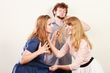 Aggressive mad women fighting over man.