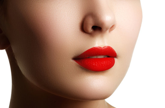 Close-up shot of woman lips with red lipstick. Beautiful perfect makeup