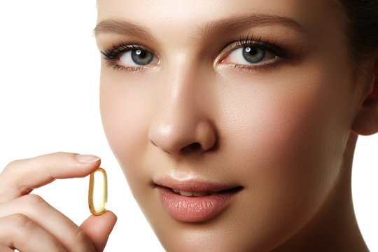 Portrait Of Woman With Omega 3 Fish Oil Capsule