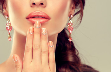 Luxury fashion style, manicure nail , cosmetics and make-up . beige nails with rhinestones .Beauty...