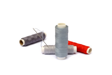 Needle, thimble, scissors, thread isolated on white background