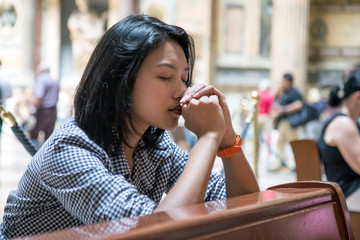 Woman praying in church