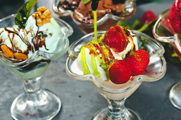 Beautiful ice cream with fruits and berries in a glass container
