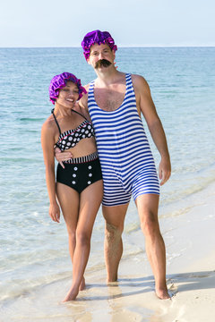 Woman With A Man In A Retro Swimsuit On The Beach