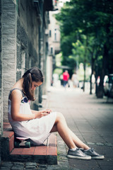 girl sit on skate use smartphone