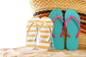 tropical sandy beach, straw bag and and flip flops