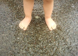 Baby foot on the wet sand
