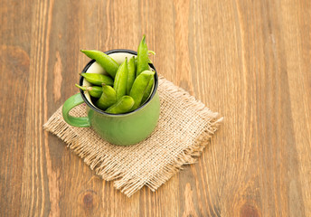 Green pea in bowl  on rustic wooden background