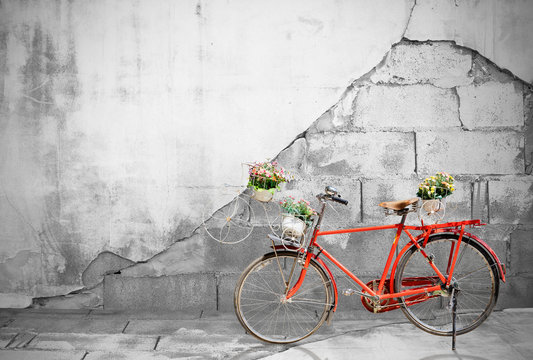 Red bicycle on Old brick wall background.