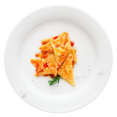 Ravioli with tomato sauce and herbs, isolated