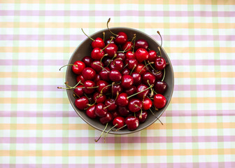 Cherries in a bowl on  marble table