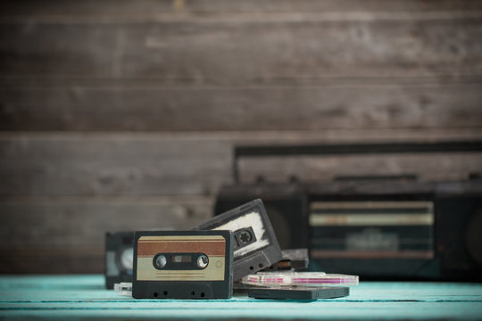 old cassette tape and player on the wood background
