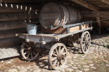 Fototapeta na wymiar Old rural wooden cart, water tank