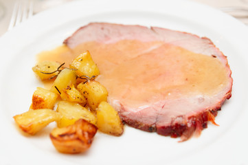 Piece of roasted beef with fried potatoes