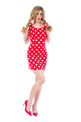 Blonde sexy girl in a red dress with beautiful hair Portrait in full growth on a white background.