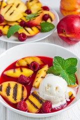 Cold fruit soup with raspberry, grilled nectarines, ice cream, vertical