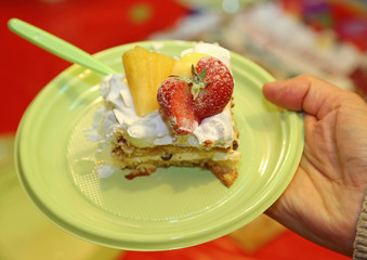 sweet cake with whipped cream and fresh fruit in the dish