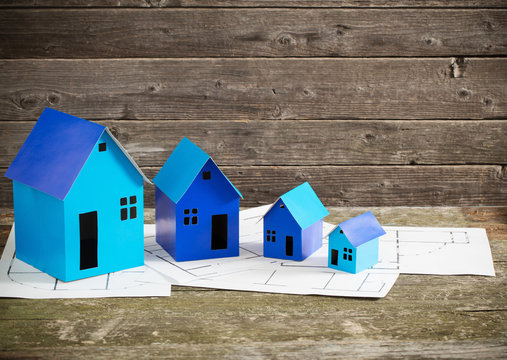 blue paper houses on wooden background