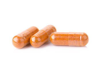 Turmeric powder inside a capsule isolated on white