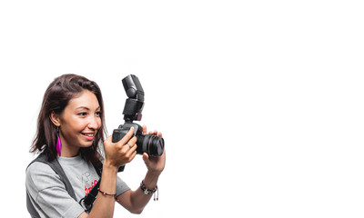 Dark haired woman taking a photo with a modern camera with flash