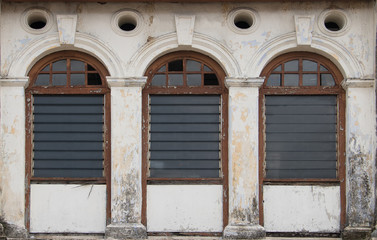 Antique glass windows on an old building. Architectural elements.