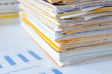 Stack of documents at business office,financial reports and statements,high key tone.