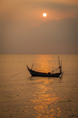 Sunset on the Phu Quoc island Siam Gulf. Silhouette vietnamese fishing boat in the close-up