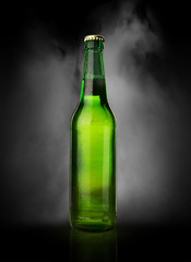 Cold wet beer bottle with frost and vapor