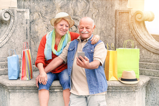 Senior couple taking selfie after shopping with smartphone 