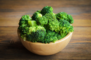 Raw broccoli on wooden table