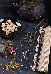 Variety of dry tea with teapot