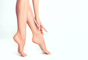 Beautiful well-groomed female legs . Foot care . Epilation and depilation of hair on the feet...