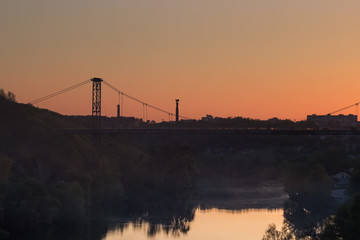 silhouette of people traveling across bridge