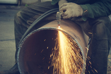 Metal cutting with acetylene torch.