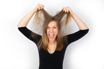 Fototapeta premium Young crazy woman with unkempt hair shouts