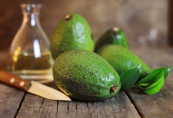 avocado and oil on wooden background