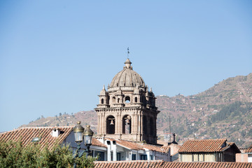 Fototapeta na wymiar Cathedral bell tower above roofline of city