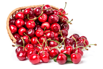 cherries in a wicker basket isolated on white background