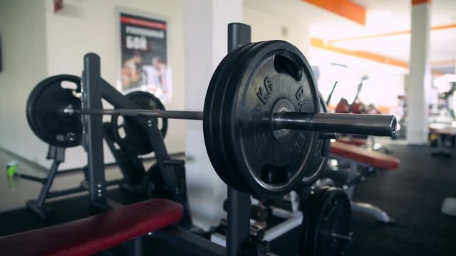 Male Athlete Puts Weight On The Barbell