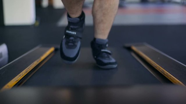 Male Athlete Running On Treadmill In The Gym