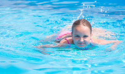 Fototapeta na wymiar Девочка подросток плавает в бассейне 