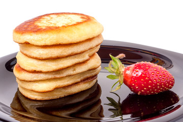 fritters on a plate with strawberries isolated white background