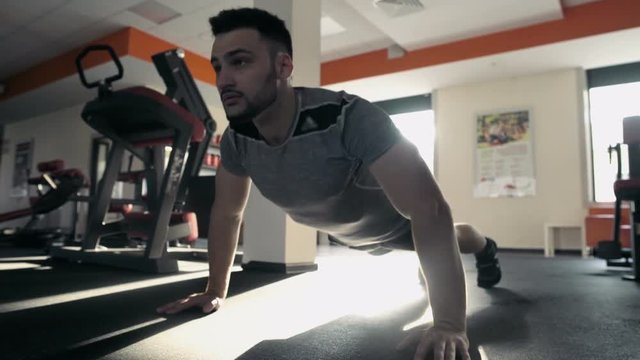 Young Male Athlete Doing Push Ups In The Gym