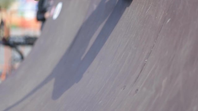 Blurred legs of skateboarder which start ride on board from ramp